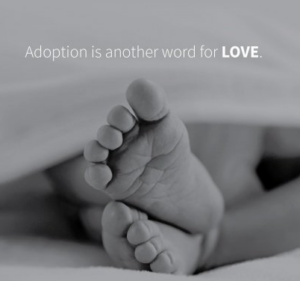 A black and white photo of a baby's feet being pictured below the text "Adoption is another word for Love1"