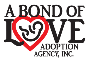 A Bond of Love Adoption's logo heart with a baby icon.