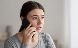 worried woman on the phone