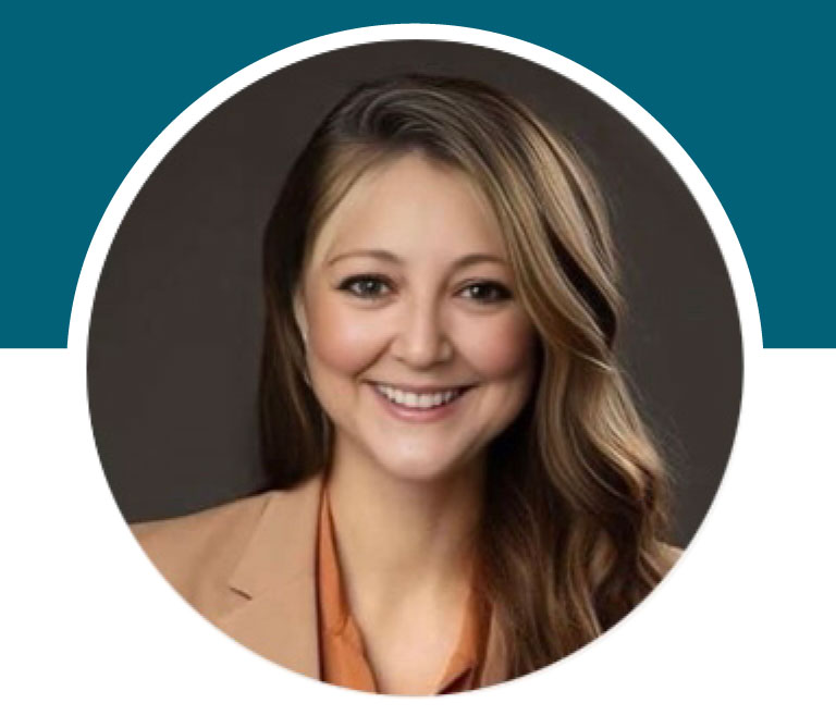 Lady smiling wearing a business suit jacket.