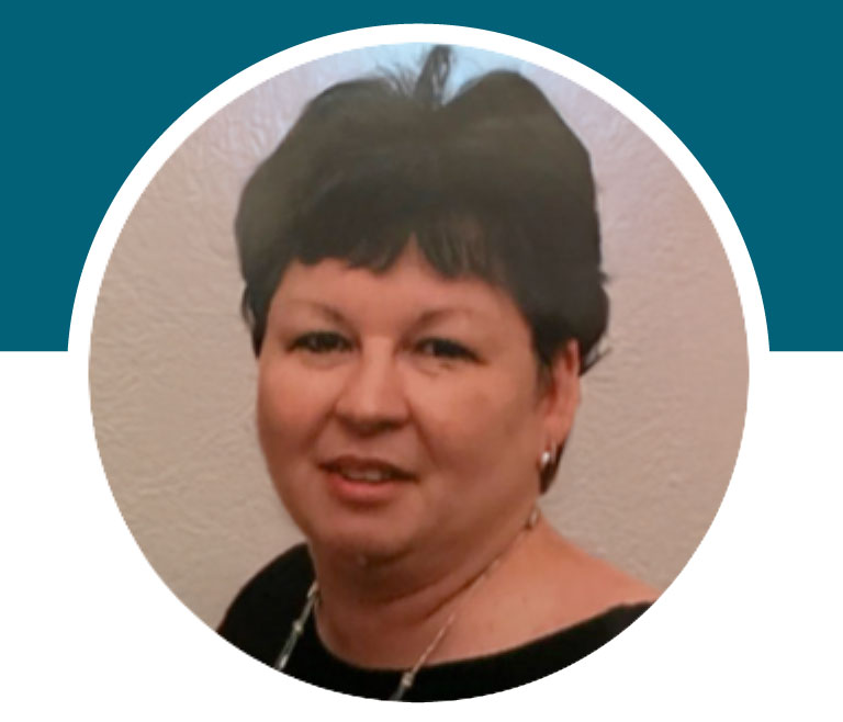 Lady with short brown hair, smiling for a photo